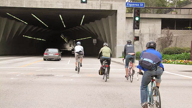 bikers riding into tunnel